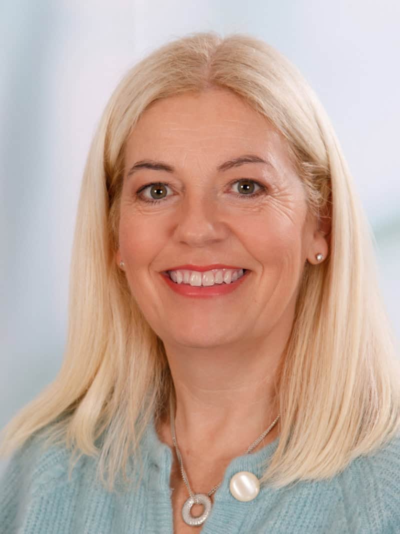 Professional woman smiling, counselling and mental health support in the UK.